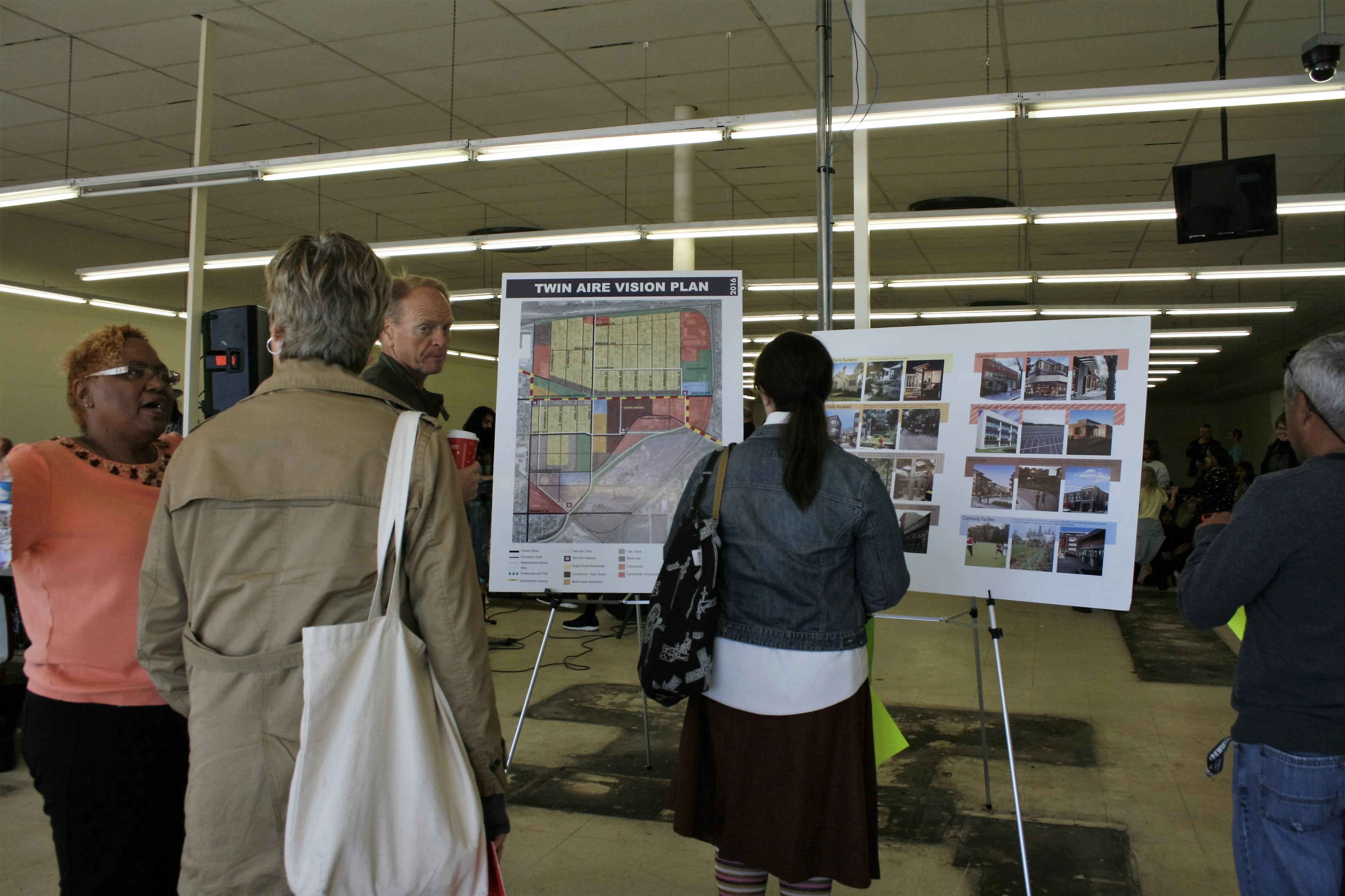 Group of people looking at signs in Twin Aire