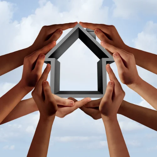 stock image of hands holding a house