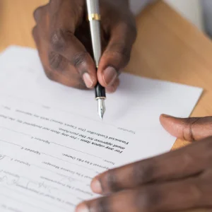 Person about to sign a document